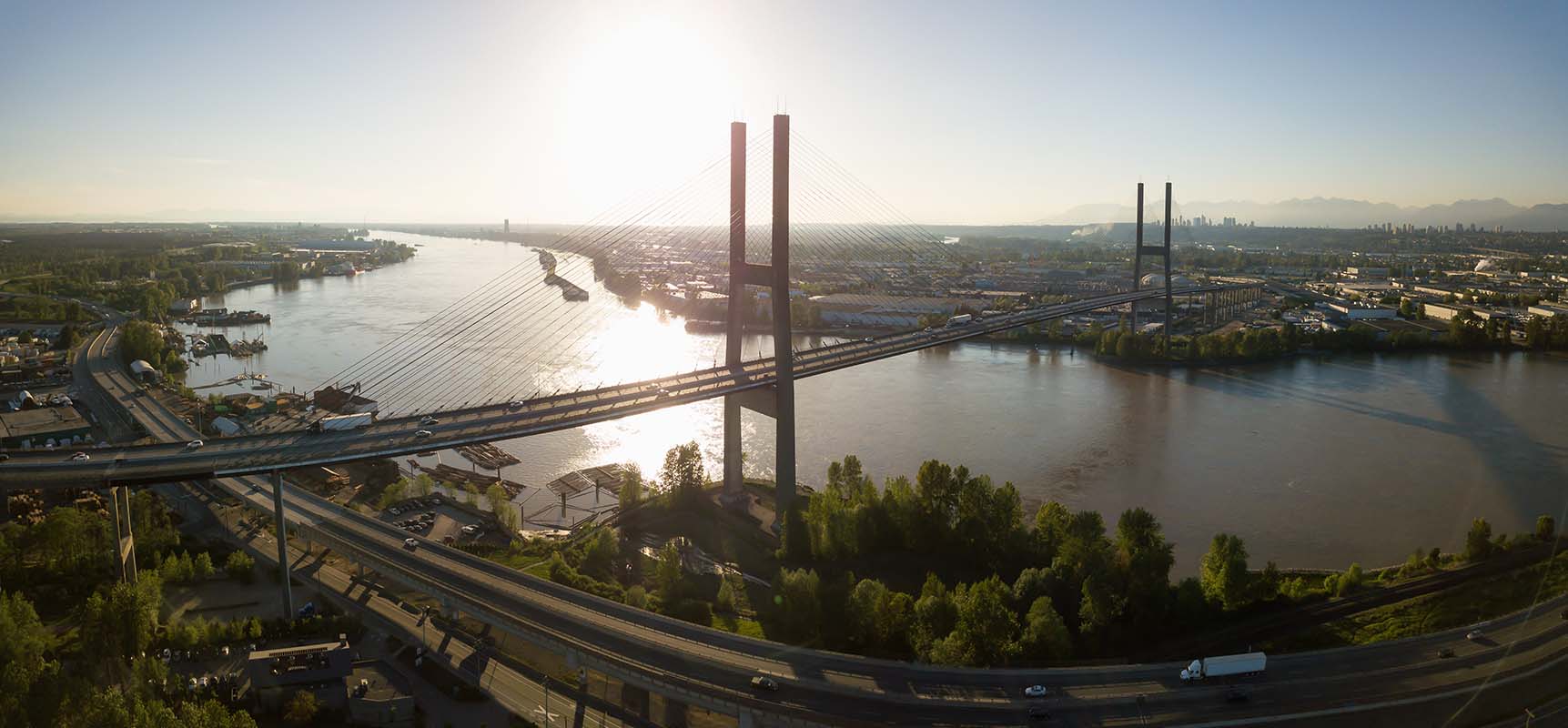 Aerial view of Alex Fraser Bridge during a vibrant sunny day. Taken in North Delta, Greater Vancouver, BC, Canada.