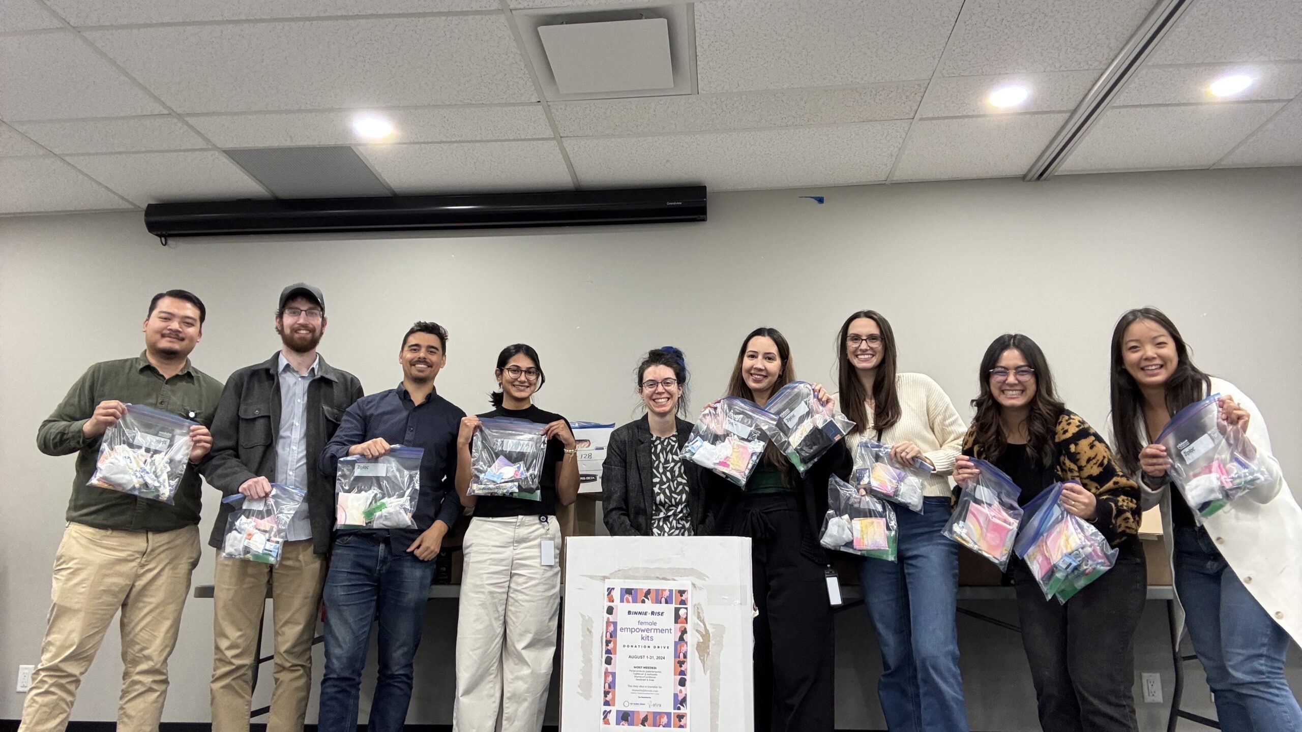 Binnie RISE team packing female empowerment kits