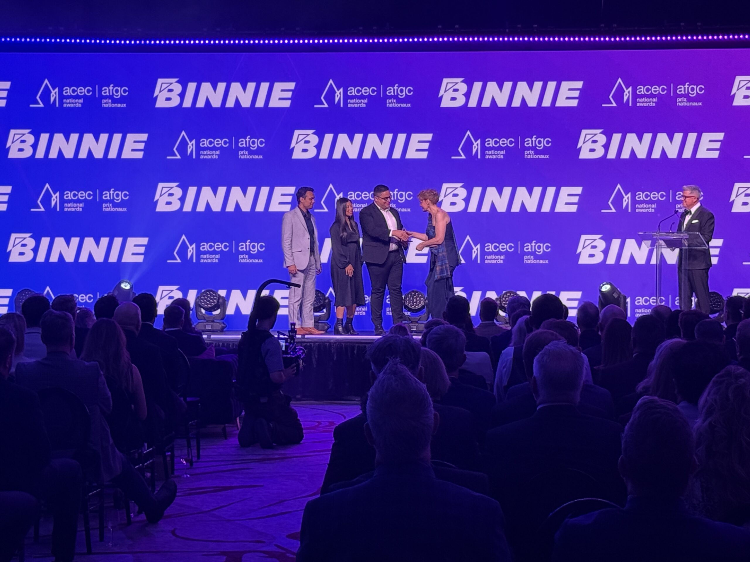 Binnie receiving award at 2026 ACEC National Gala